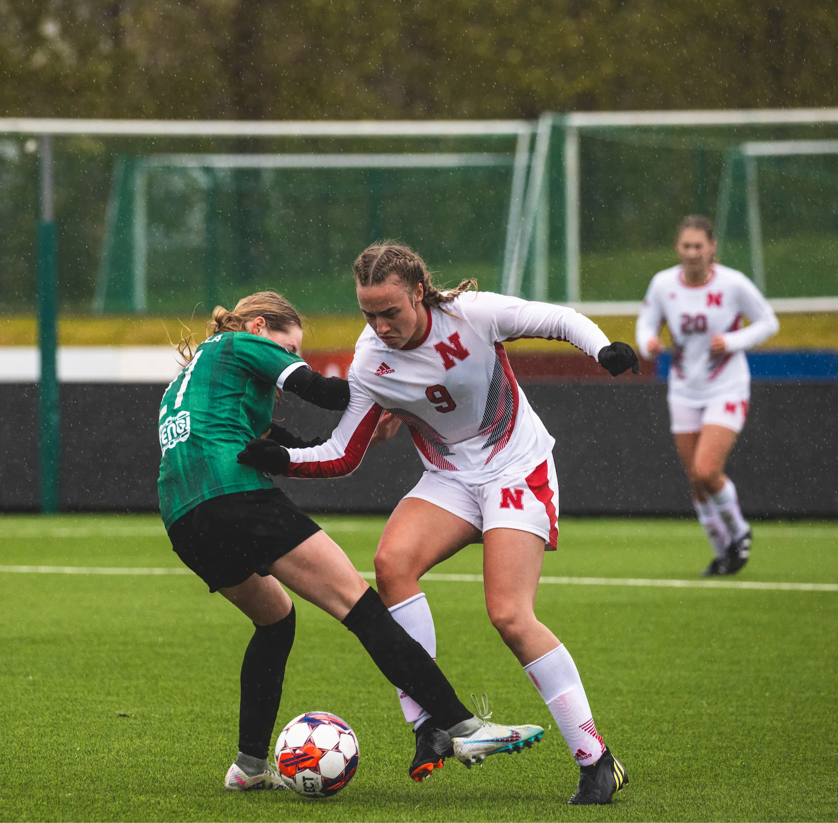 Visiting soccer players competing on the pitch