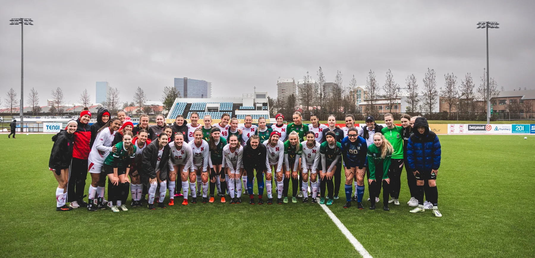 A visiting team together on a soccer field in Iceland